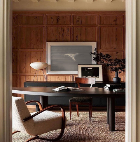a large abstract canvas art hanging on the living room's wall