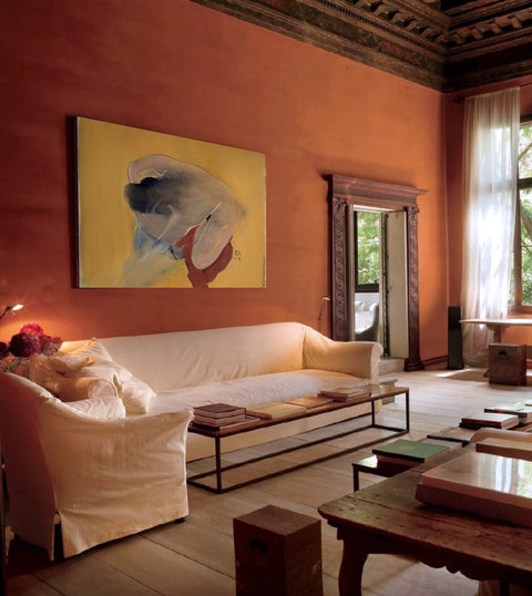 a large abstract canvas art hanging on the living room's wall
