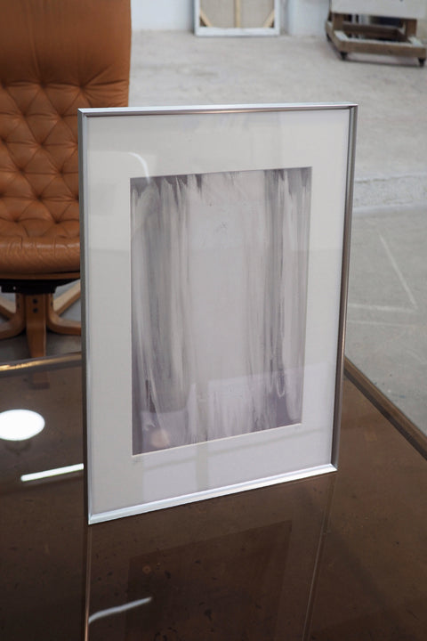 a large abstract canvas art hanging on the living room's wall