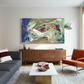 Modern living room with a gray sofa, orange chair, and abstract painting on the wall. Depth – Bold Abstract Canvas Print | Large Luxury Wall Art | Brume Art