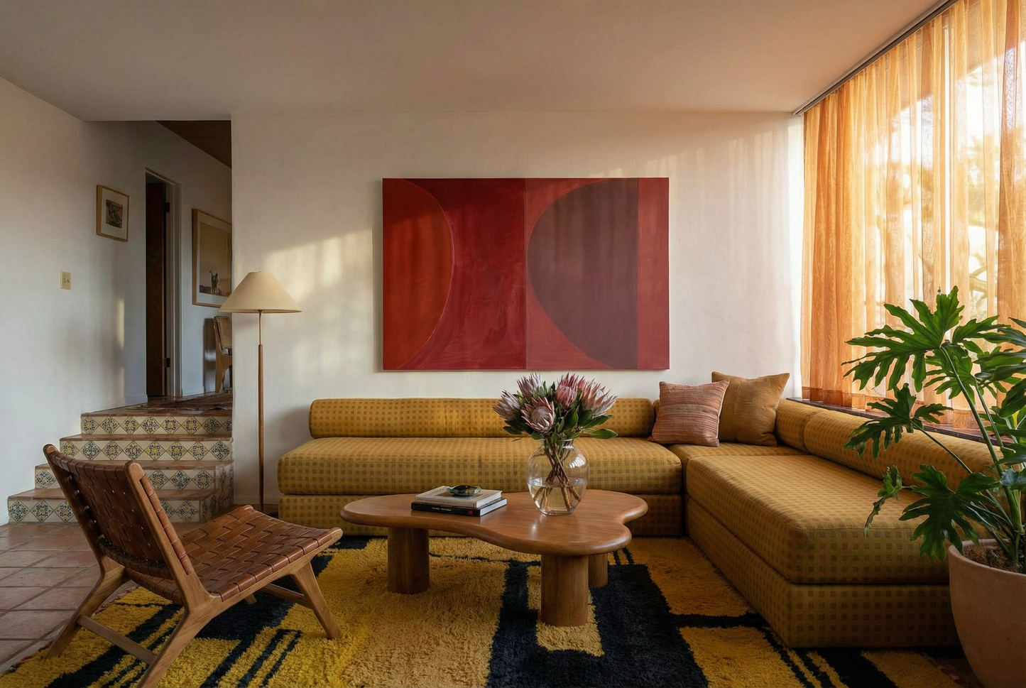 Living room with a yellow sectional sofa, wooden coffee table, and abstract red painting on the wall. Eclipse – Contemporary Abstract Canvas | Oversized Luxury Wall Art | Brume Art