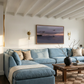 Living room with a blue sectional sofa, wooden coffee table, and wall art. Away – Minimalist Abstract Canvas Art | Large Luxury Wall Decor | Brume Art