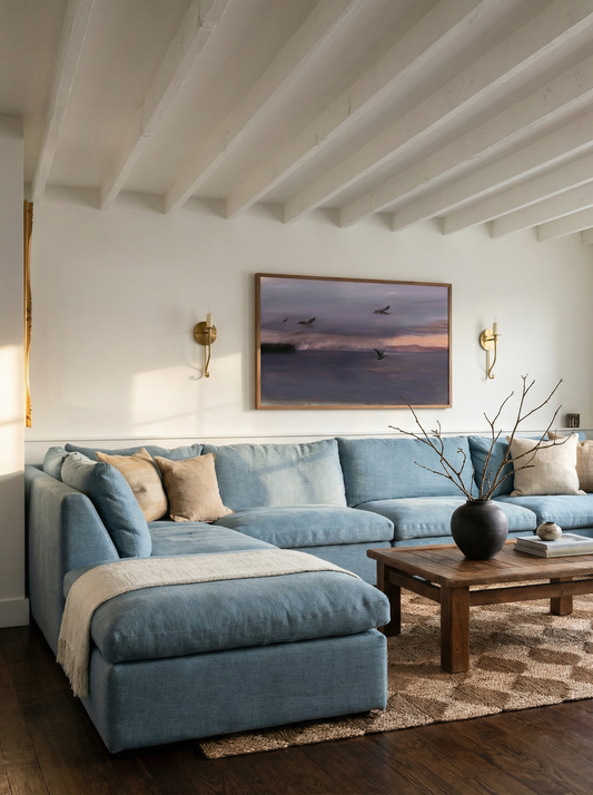 Living room with a blue sectional sofa, wooden coffee table, and wall art. Away – Minimalist Abstract Canvas Art | Large Luxury Wall Decor | Brume Art