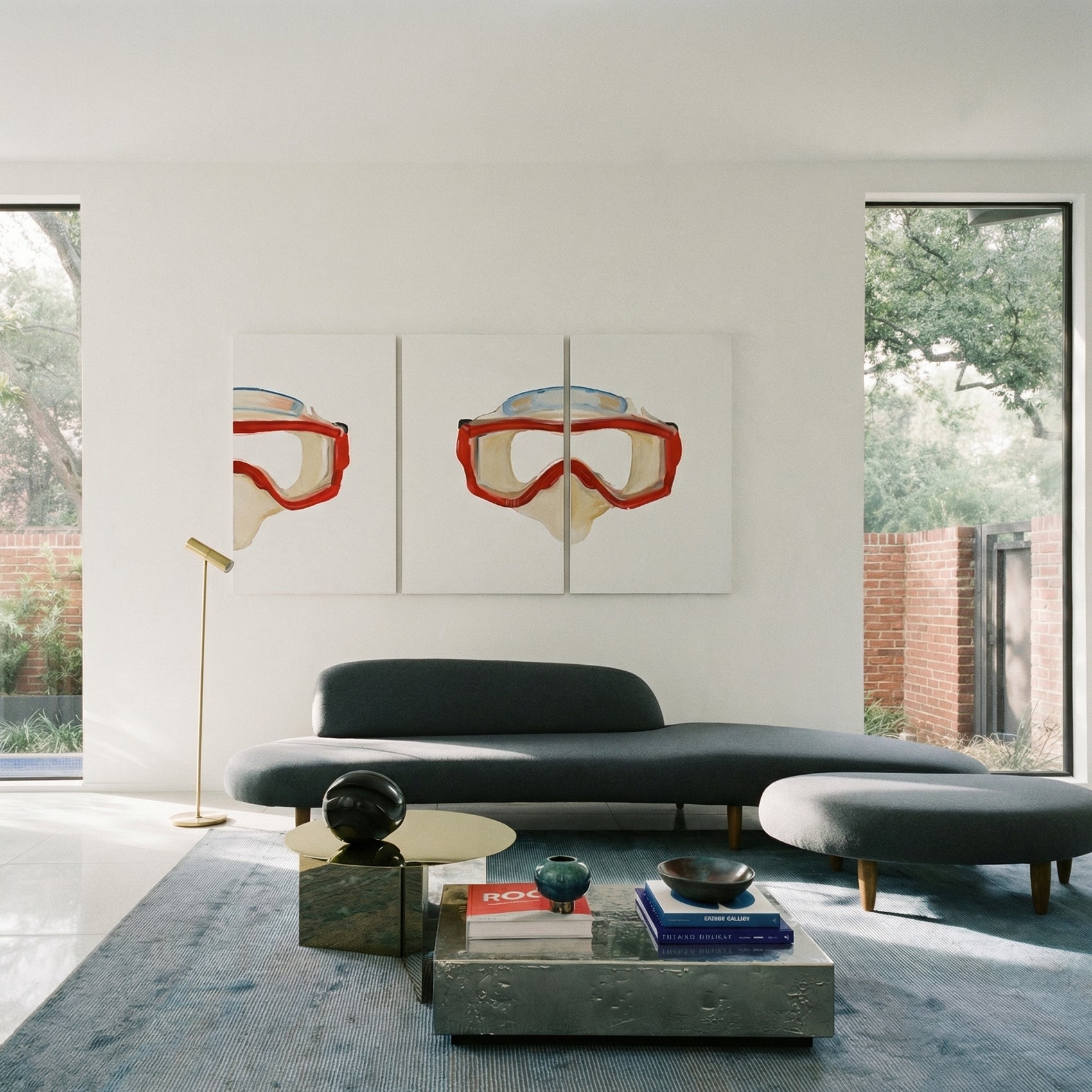 Modern living room with a gray sofa, coffee table, and wall art of goggles. Diving Mask – Unique Figurative Canvas Art | Premium Wall Decor | Brume Art