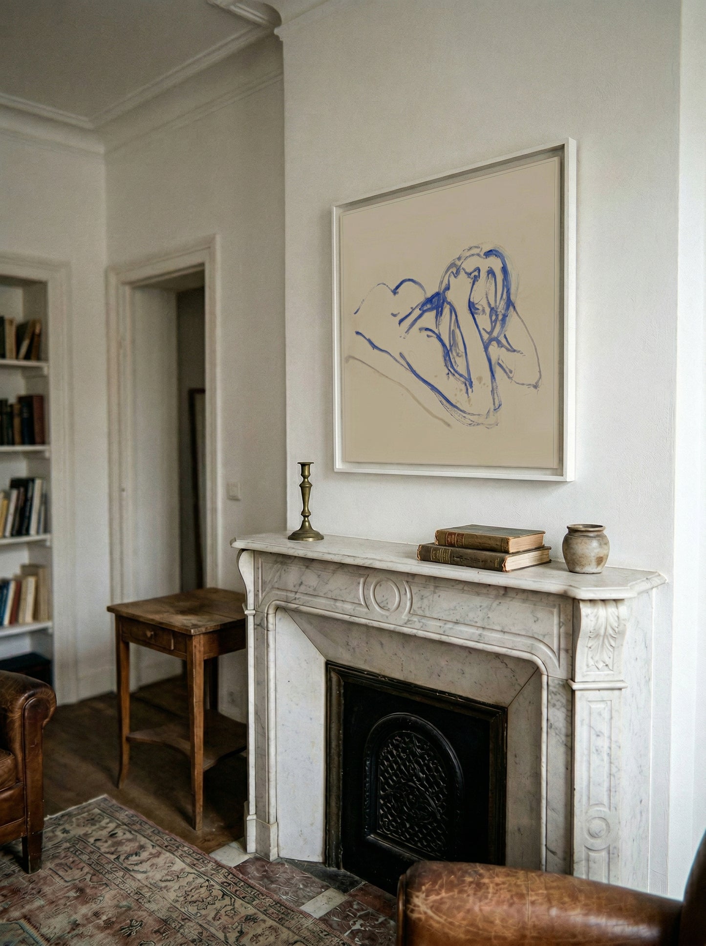 Living room with marble fireplace, artwork above, and books on a shelf. Presence 3 – Figurative Abstract Canvas | Premium Wall Art | Brume Art | Luxury Wall Decor | Large Canvas Wall Art | Oversized Wall Hanging-Brume art