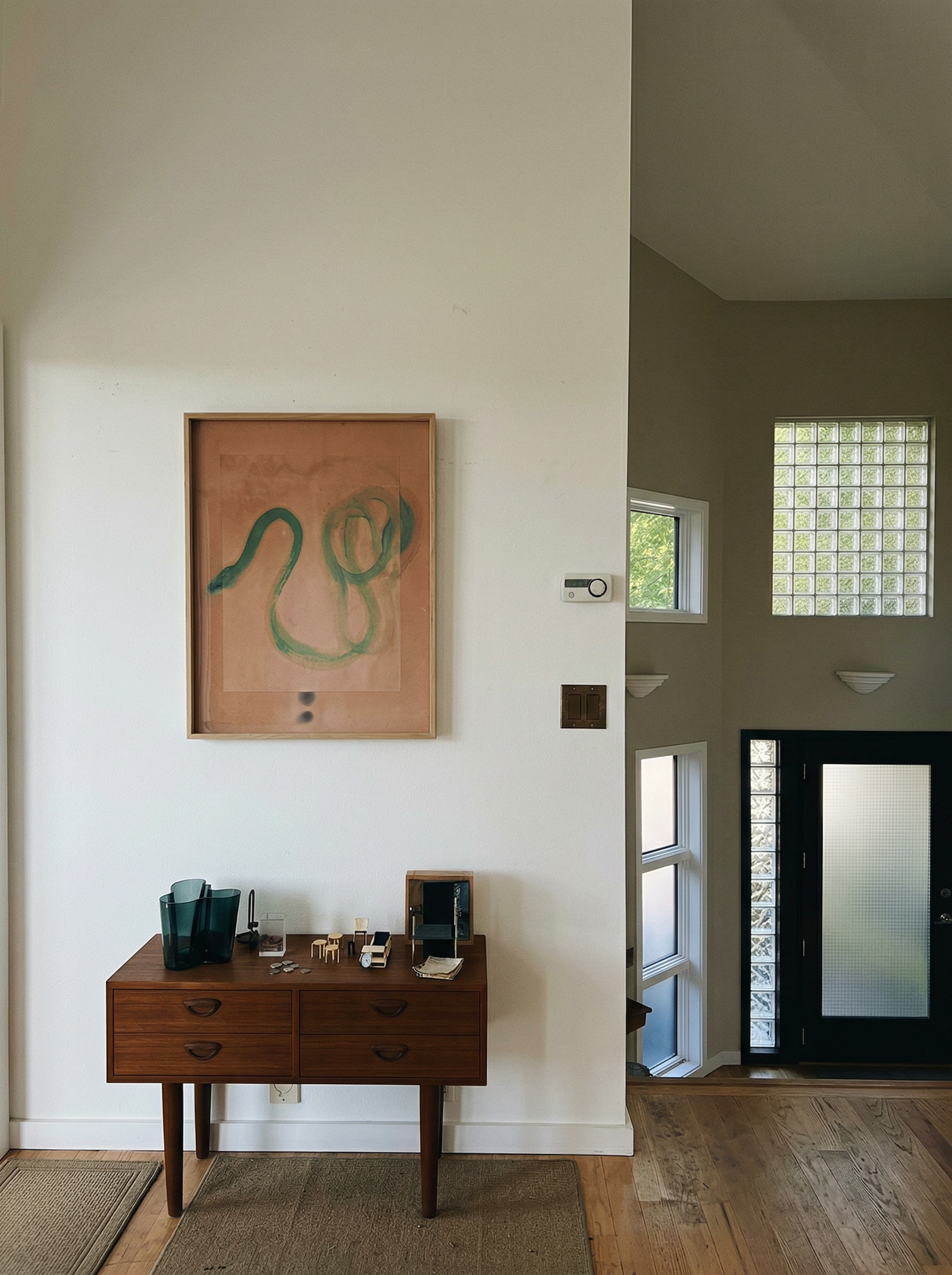 Wooden desk with decorative items against a white wall with a framed artwork. Green Snake 2 – Nature Canvas Wall Art | Premium Luxury Print | Brume Art