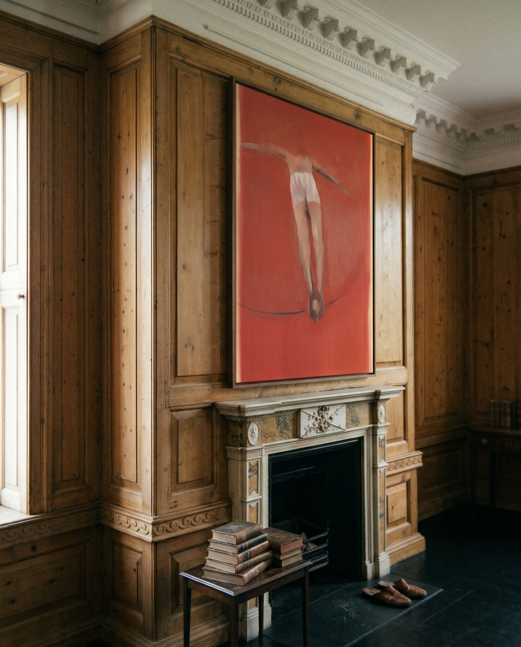 Artistic depiction of a leg on a red background in an elegant room with wooden paneling and a fireplace. Into Red – Bold Abstract Canvas Wall Art | Large Luxury Print | Brume Art