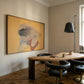 Modern dining room with a round wooden table and black chairs, featuring a large framed artwork on the wall. Soft Body – Figurative Abstract Canvas Print | Premium Wall Art | Brume Art