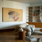 Living room with a beige armchair, coffee table, and bookshelf. Soft Body – Figurative Abstract Canvas Print | Premium Wall Art | Brume Art
