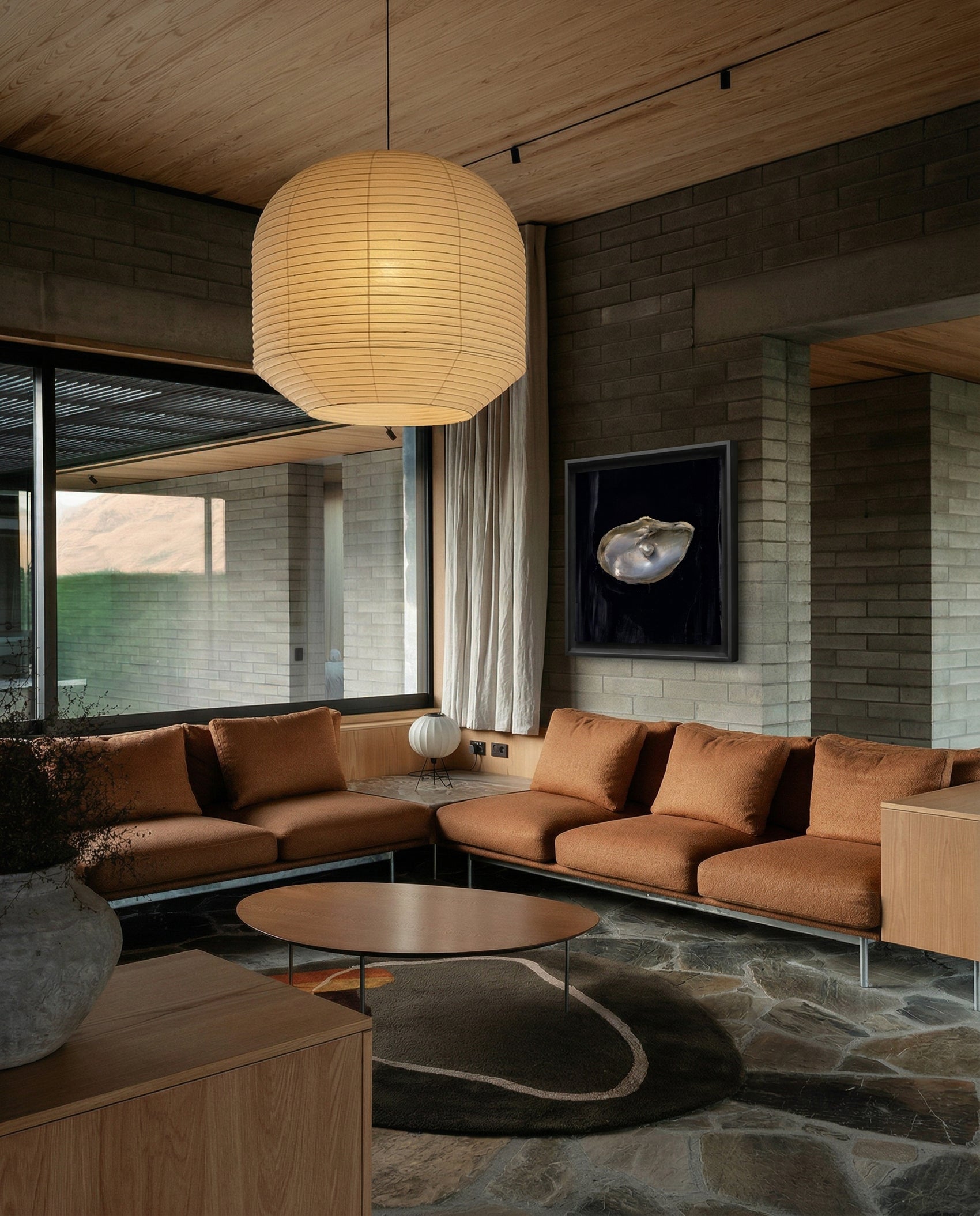 Modern living room with brown sectional sofa, round coffee table, and pendant light. Pearl – Elegant Abstract Canvas Wall Art | Luxury Giclée Print | Brume Art