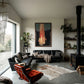 Modern living room with black leather sofa, red armchair, and decorative elements. Flame – Expressive Abstract Canvas Art | Large Luxury Wall Print | Brume Art