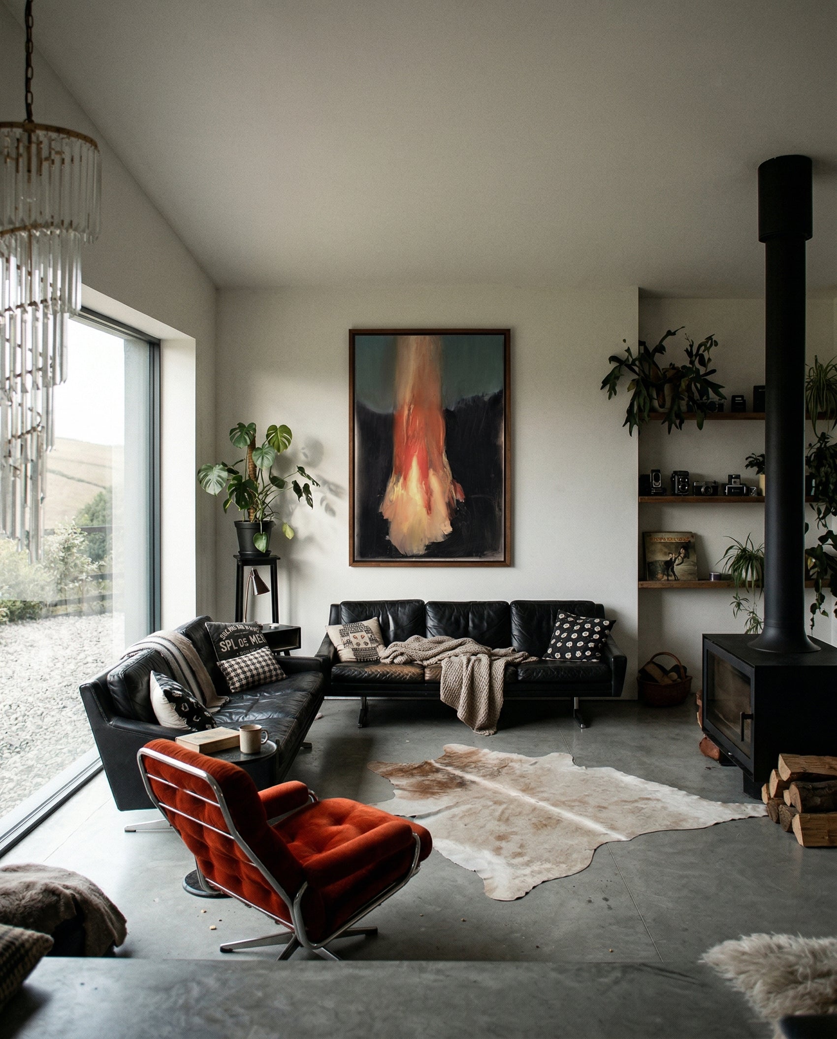 Modern living room with black leather sofa, red armchair, and decorative elements. Flame – Expressive Abstract Canvas Art | Large Luxury Wall Print | Brume Art