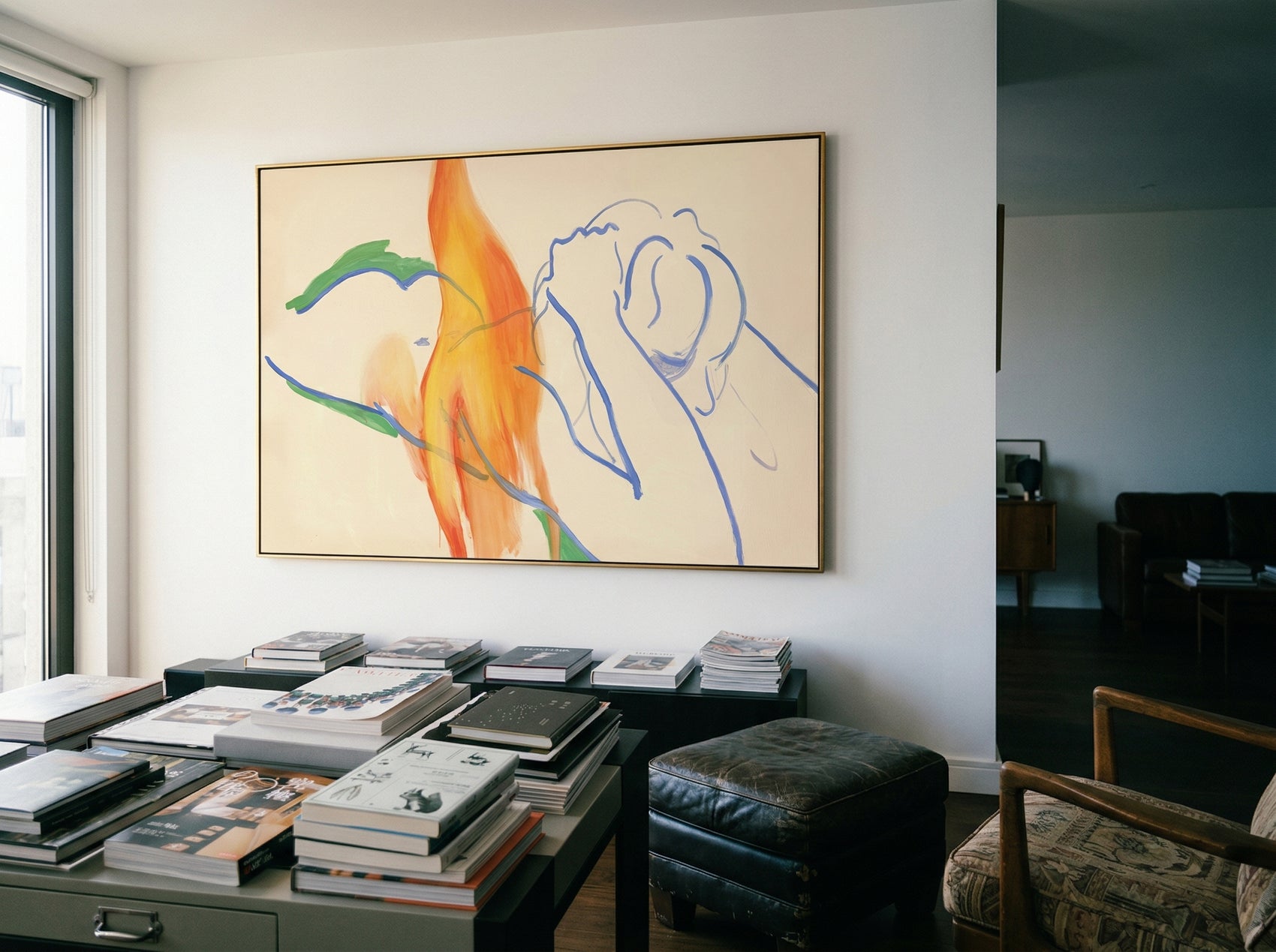 Abstract artwork on a wall above a table with books in a room. Figure and Flame – Figurative Canvas Wall Art | Premium Luxury Print | Brume Art