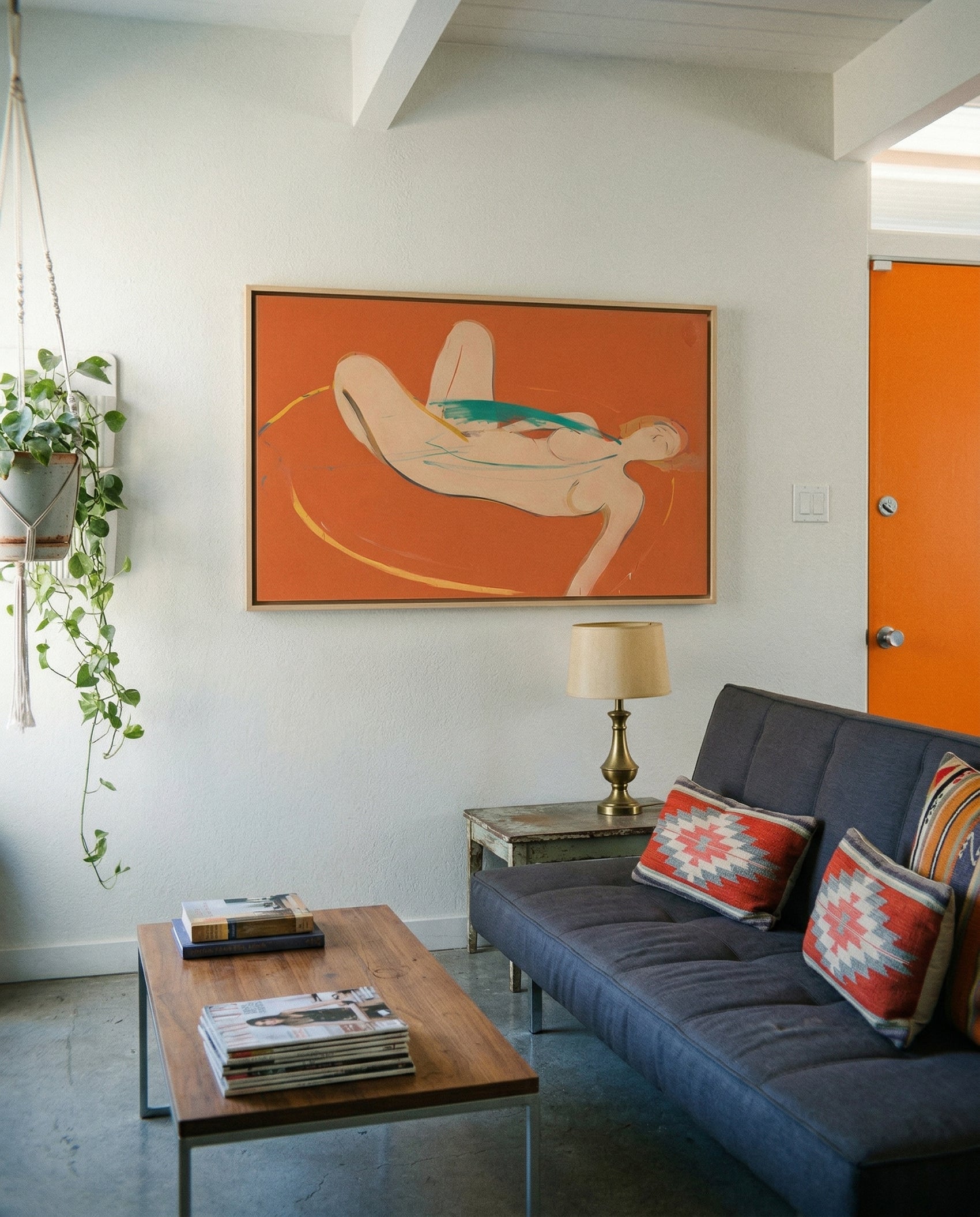 Modern living room with a blue sofa, wooden coffee table, and abstract painting on the wall. Envelope in Orange – Warm Abstract Canvas Art | Luxury Wall Decor | Brume Art