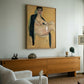 Living room with a large painting on the wall above a wooden console table. Girl with Short Hair – Portrait Canvas Art | Luxury Wall Decor | Brume Art