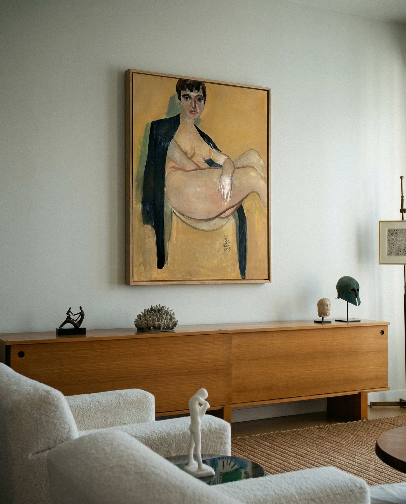Living room with a large painting on the wall above a wooden console table. Girl with Short Hair – Portrait Canvas Art | Luxury Wall Decor | Brume Art
