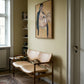 Beige chair in a room with a painting on the wall Girl with Short Hair – Portrait Canvas Art | Luxury Wall Decor | Brume Art