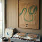 Record player with vinyl records and a painting of a snake on the wall. Green Snake 2 – Nature Canvas Wall Art | Premium Luxury Print | Brume Art