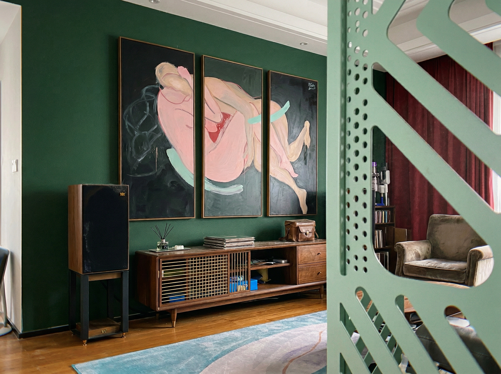 Living room with green walls, a wooden cabinet, and large abstract paintings. Embrace – Figurative Canvas Wall Art | Oversized Luxury Print | Brume Art