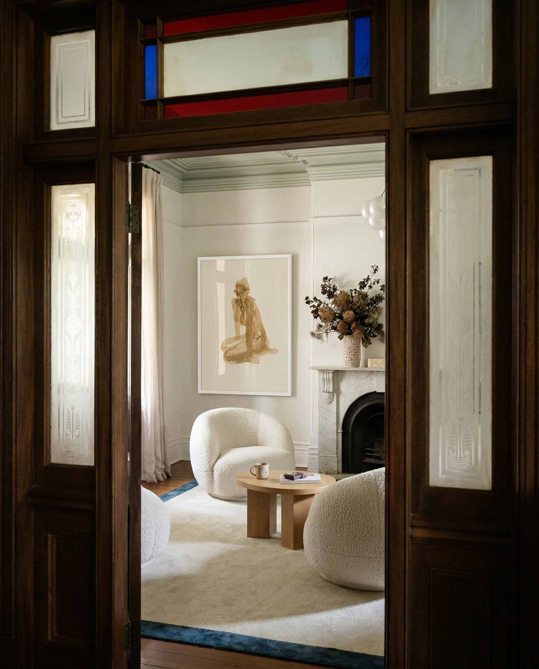 Living room with white armchair, coffee table, and decorative elements through a glass door. Still 3 – Serene Abstract Canvas Print | Premium Luxury Wall Art | Brume Art