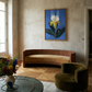 Modern living room with a curved wooden sofa, round glass coffee table, and floral arrangement. Iris – Botanical Canvas Wall Art | Premium Luxury Print | Brume Art