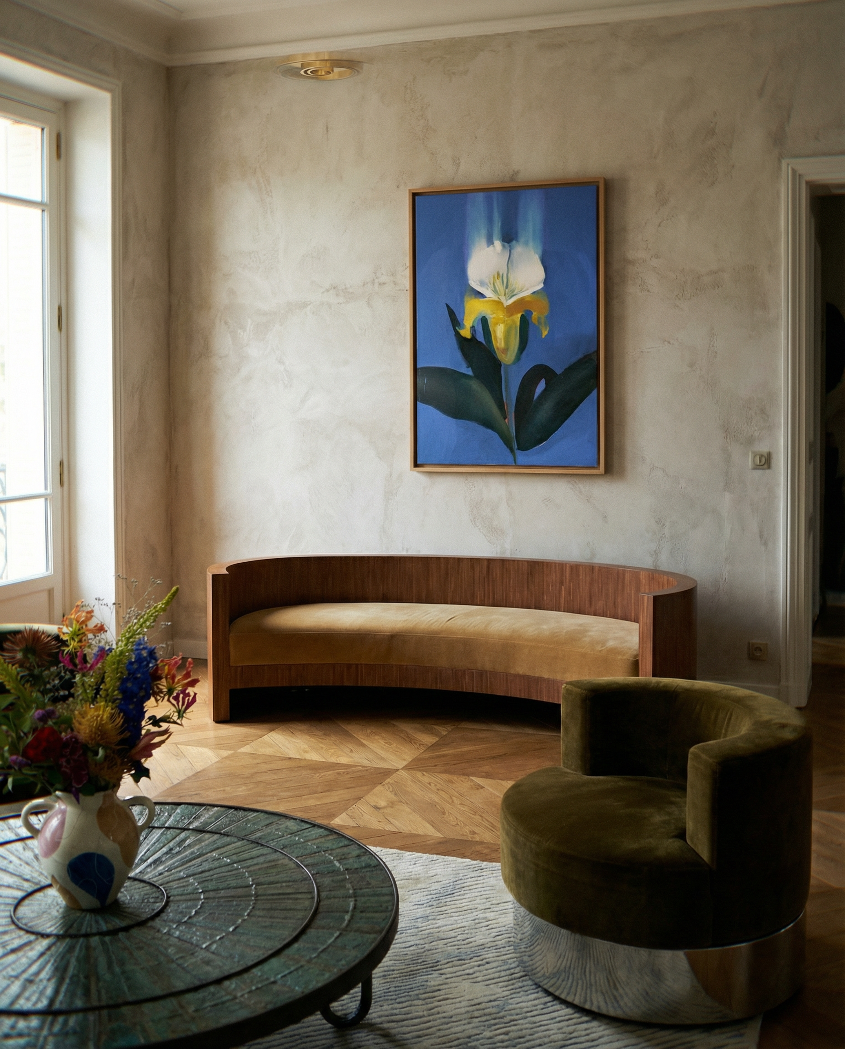 Modern living room with a curved wooden sofa, round glass coffee table, and floral arrangement. Iris – Botanical Canvas Wall Art | Premium Luxury Print | Brume Art