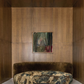 Decorative sofa with patterned cushions against a wooden paneled wall with a painting. Field green – Bold Abstract Canvas Wall Art | Large Luxury Print | Brume Art 
