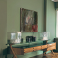 Wooden console table with glass top against a green wall with a painting. Field green – Bold Abstract Canvas Wall Art | Large Luxury Print | Brume Art 