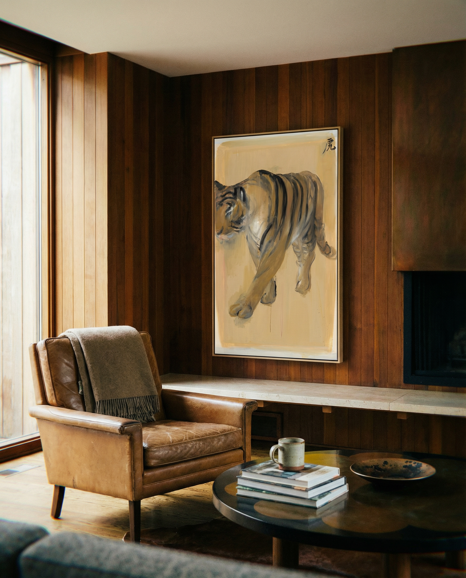 Living room with a brown leather armchair, coffee table, and tiger painting on wooden wall. Tiger – Contemporary Animal Canvas Art | Luxury Wall Decor | Brume Art