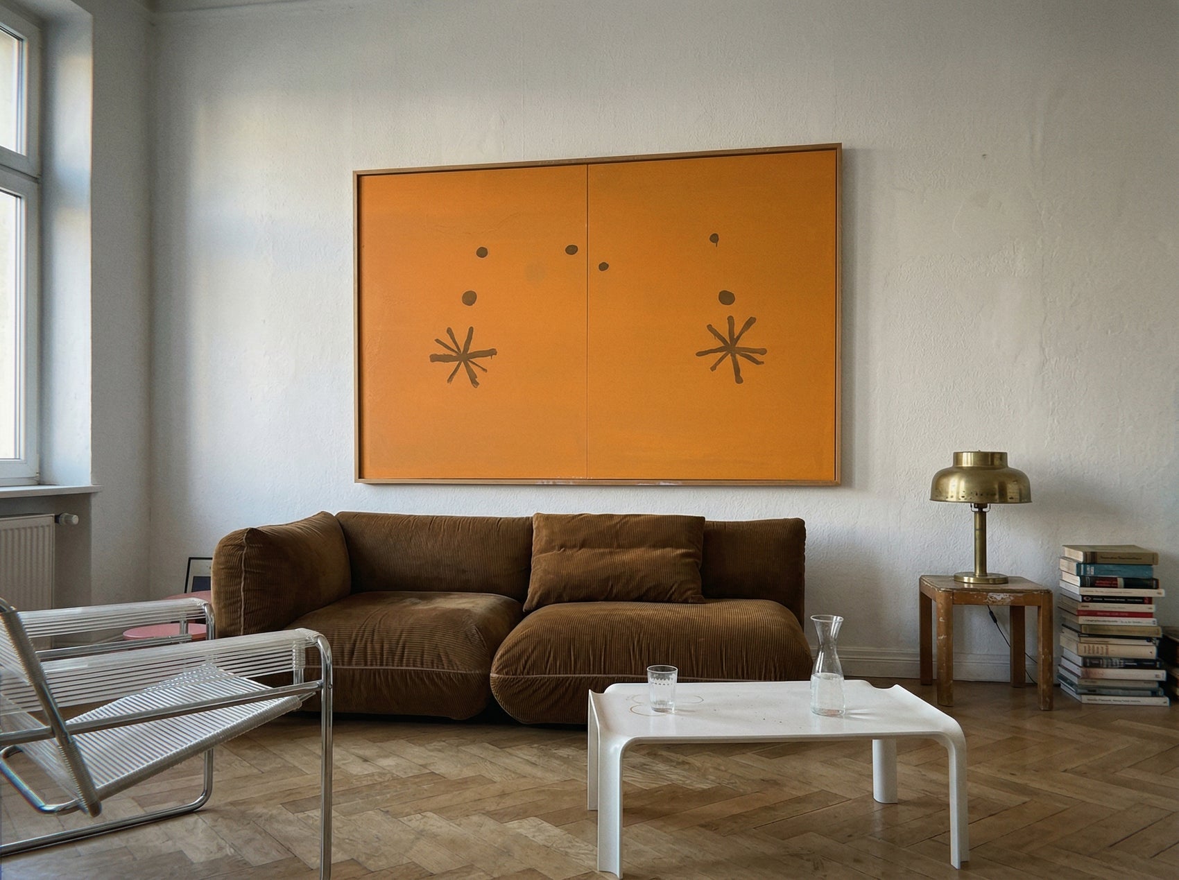 Modern living room with a brown sofa, white coffee table, and orange abstract art on the wall. Marks – Bold Abstract Canvas Wall Art | Premium Luxury Print | Brume Art