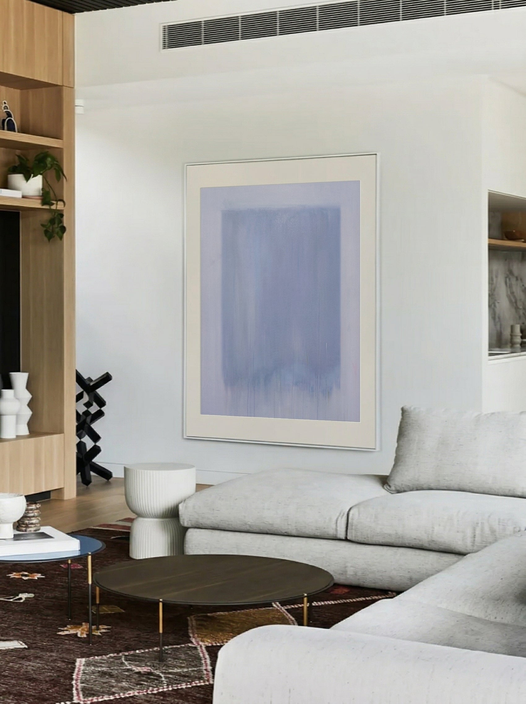 Modern living room with a gray sofa, round coffee table, and abstract art on the wall. Frame – Bold Abstract Canvas Wall Art | Large Luxury Print | Brume Art