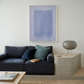 Modern living room with a dark gray sofa, abstract art, and side table. Frame – Bold Abstract Canvas Wall Art | Large Luxury Print | Brume Art
