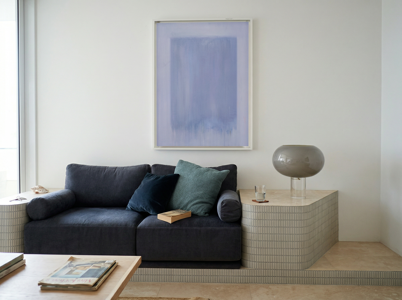 Modern living room with a dark gray sofa, abstract art, and side table. Frame – Bold Abstract Canvas Wall Art | Large Luxury Print | Brume Art