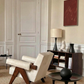 Modern armchair in a stylish living room with a bookshelf and artwork. Noise – Abstract Canvas Art | Large Luxury Wall Print | Brume Art