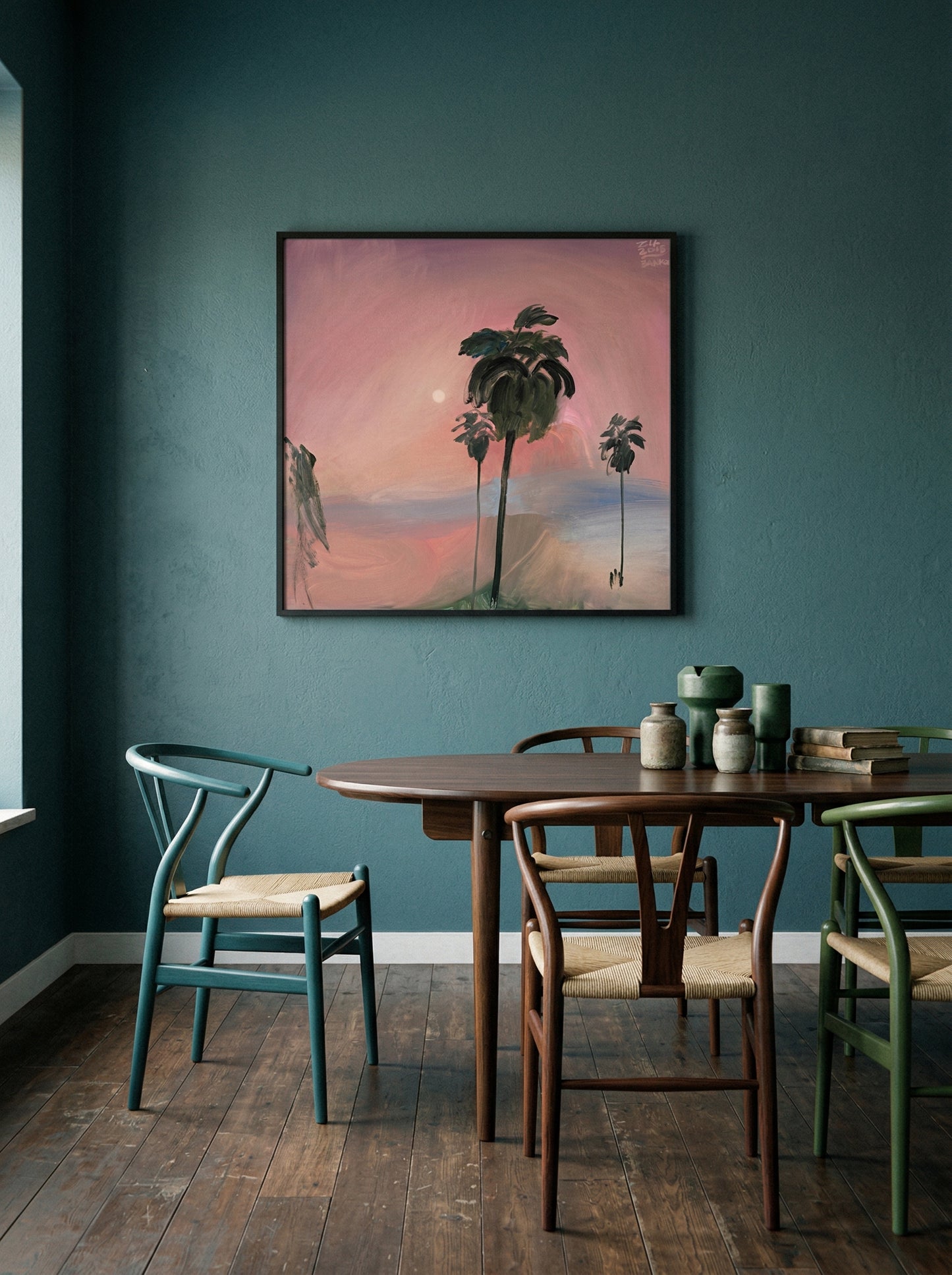 Dining room with a wooden table and chairs against a teal wall with a framed artwork of palm trees. Palm tree – Landscape Canvas Wall Art | Large Luxury Print | Brume Art 