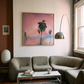Living room with a gray sofa, coffee table, and wall art of palm trees and a sunset. Palm tree – Landscape Canvas Wall Art | Large Luxury Print | Brume Art 