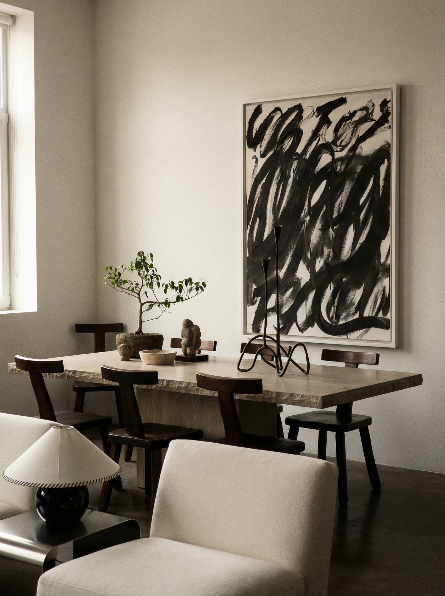 Dining room with a wooden table, chairs, and a large abstract painting on the wall. Noise 2 – Textured Abstract Canvas Art | Premium Luxury Wall Decor | Brume Art