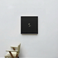 Minimalist black-framed artwork on a white wall with a chair below.Bird 2 – Elegant Nature Canvas Print | Luxury Wall Art | Brume Art