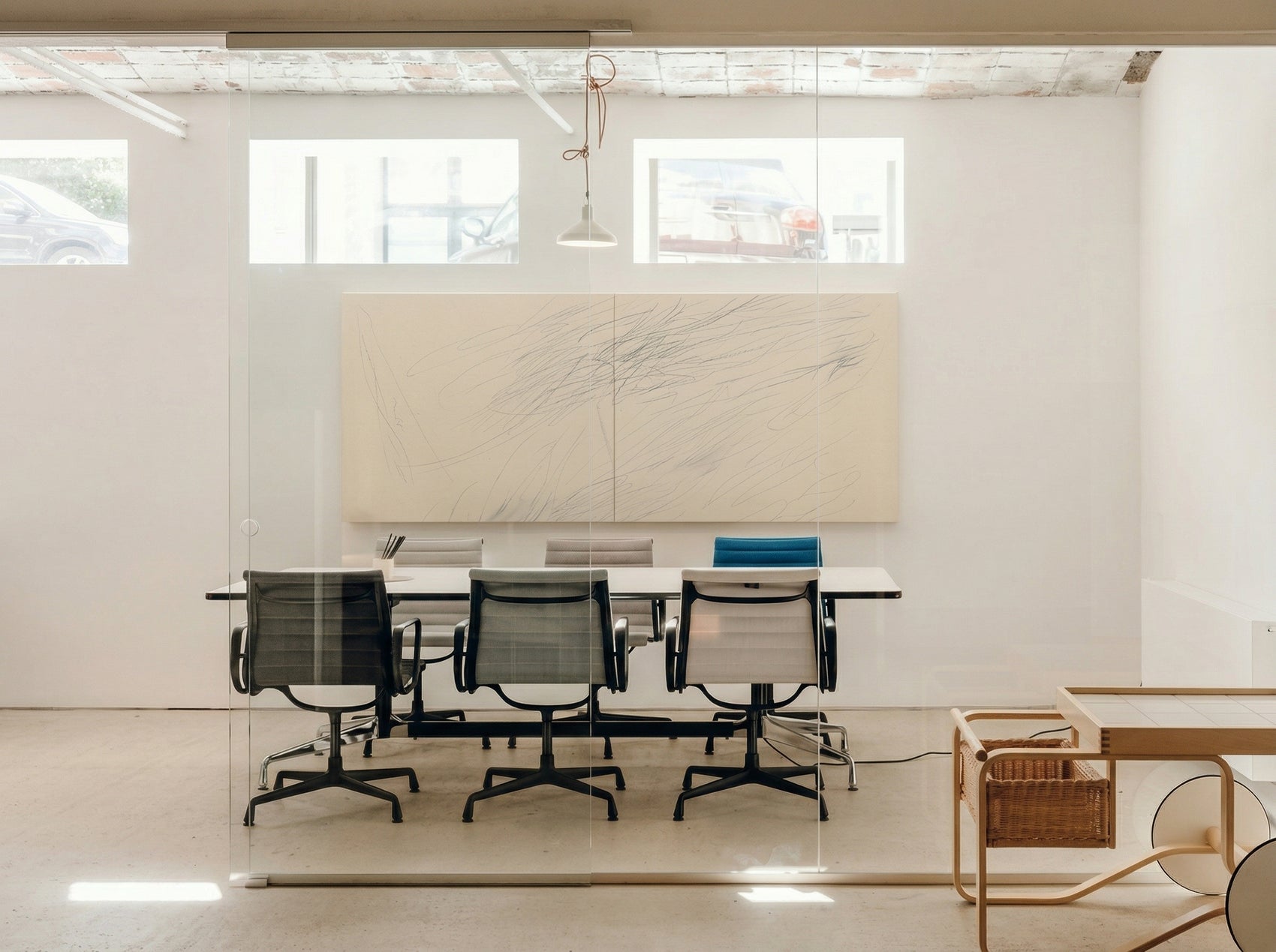 Modern office conference room with a large beige wall-mounted board and chairs around a glass table. Black lines – Bold Abstract Canvas Print | Large Luxury Wall Art