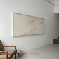 Modern interior with a large abstract painting on a white wall, a brown chair, and a staircase. Black lines – Bold Abstract Canvas Print | Large Luxury Wall Art