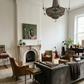 Living room with gray sofa, armchairs, and a chandelier. Bangkok girl– Figurative Canvas Wall Art | Contemporary Luxury Print | Brume Art| Luxury Wall Decor | Large Canvas Wall Art | Oversized Wall Hanging-Brume art