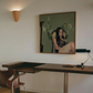 Room interior with a painting of a woman and flowers on the wall above a desk. Bangkok girl– Figurative Canvas Wall Art | Contemporary Luxury Print | Brume Art| Luxury Wall Decor | Large Canvas Wall Art | Oversized Wall Hanging-Brume art