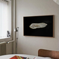 Framed artwork of an oyster on a black background in a room with a window and radiator. Pearl 2 – Elegant Abstract Canvas Wall Art | Luxury Giclée Print | Brume Art| Luxury Wall Decor | Large Canvas Wall Art | Oversized Wall Hanging-Brume art