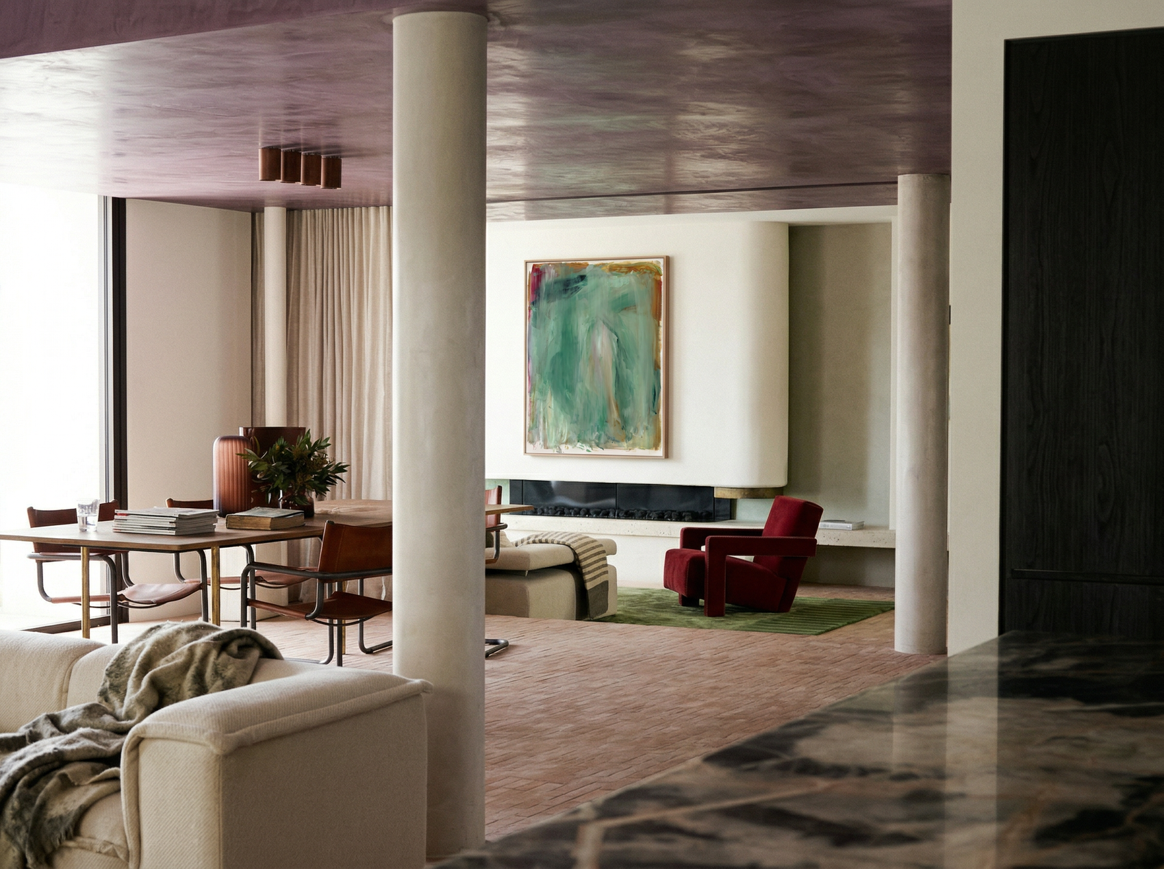 Modern living room with a painting on the wall and a couch. Abstract painting with green and brown tones on a white background Field green 2 – Abstract Canvas Wall Art | Large Luxury Print | Brume Art