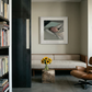 Modern interior with a sofa, bookshelf, and framed picture on a wall. Gaze – Figurative Canvas Wall Art | Premium Luxury Print | Brume Art | Luxury Wall Decor | Large Canvas Wall Art | Oversized Wall Hanging-Brume art