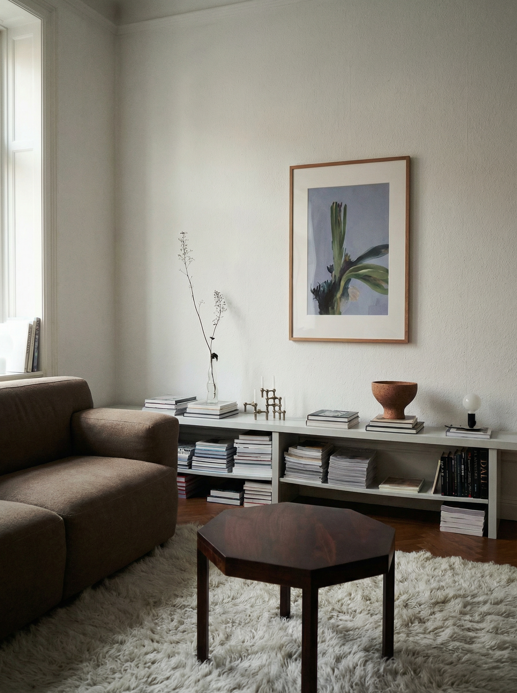 Living room with a brown sofa, hexagonal coffee table, and framed picture on the wall. Orchid – Botanical Canvas Wall Art | Large Luxury Print | Brume Art