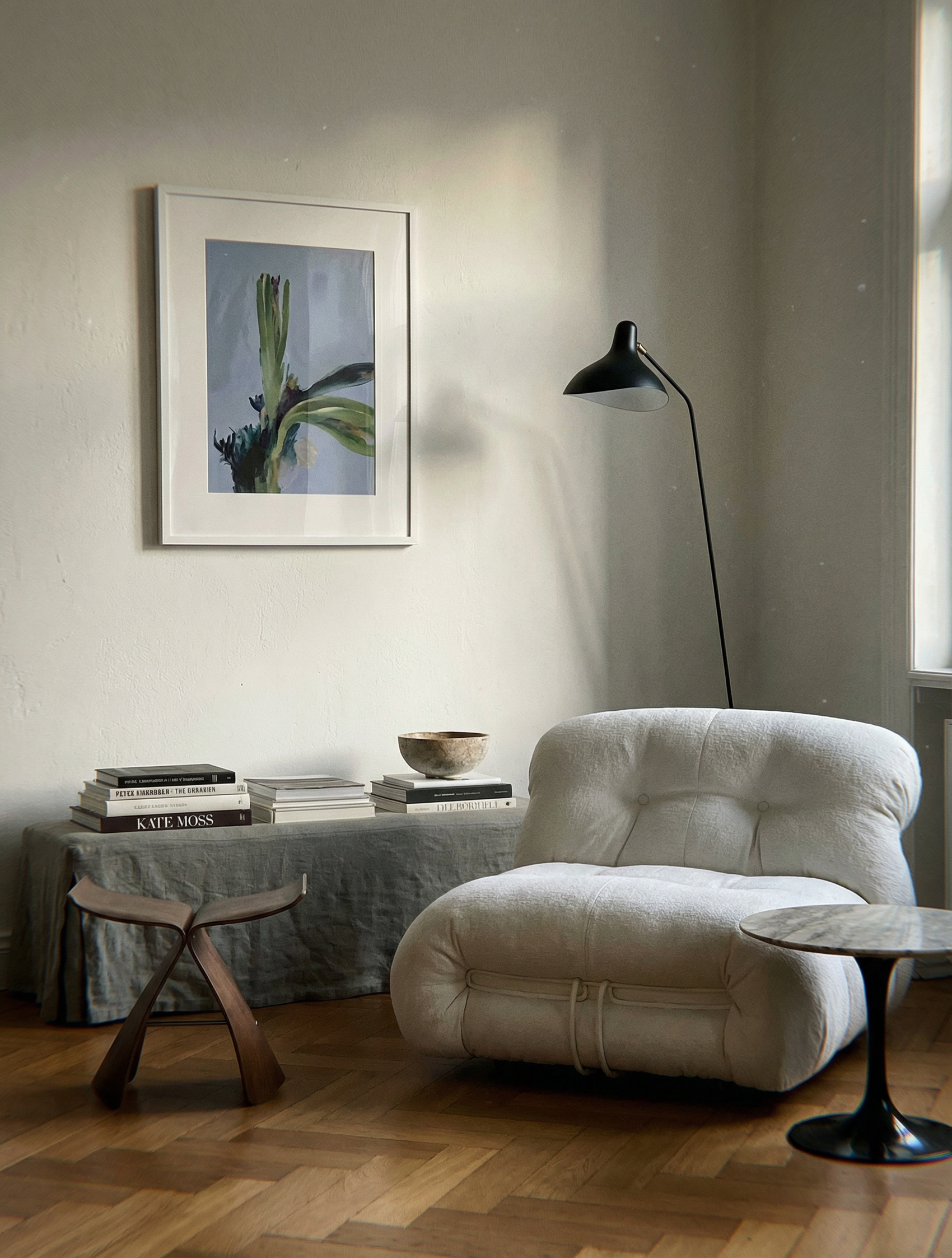 Modern living room with a white armchair, wooden stool, and framed artwork on the wall. Orchid – Botanical Canvas Wall Art | Large Luxury Print | Brume Art