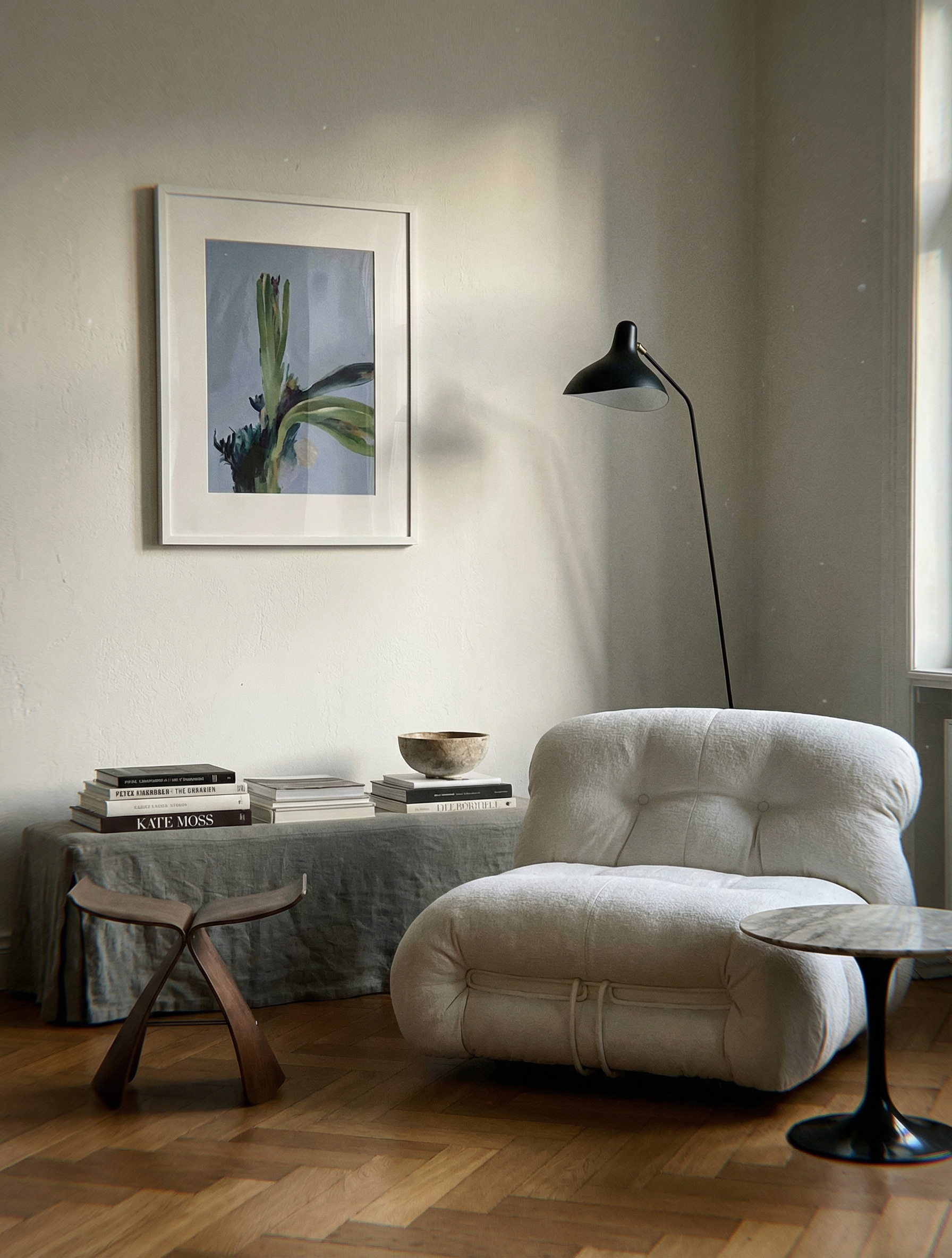 Modern living room with a white armchair, wooden stool, and framed artwork on the wall. Orchid – Botanical Canvas Wall Art | Large Luxury Print | Brume Art