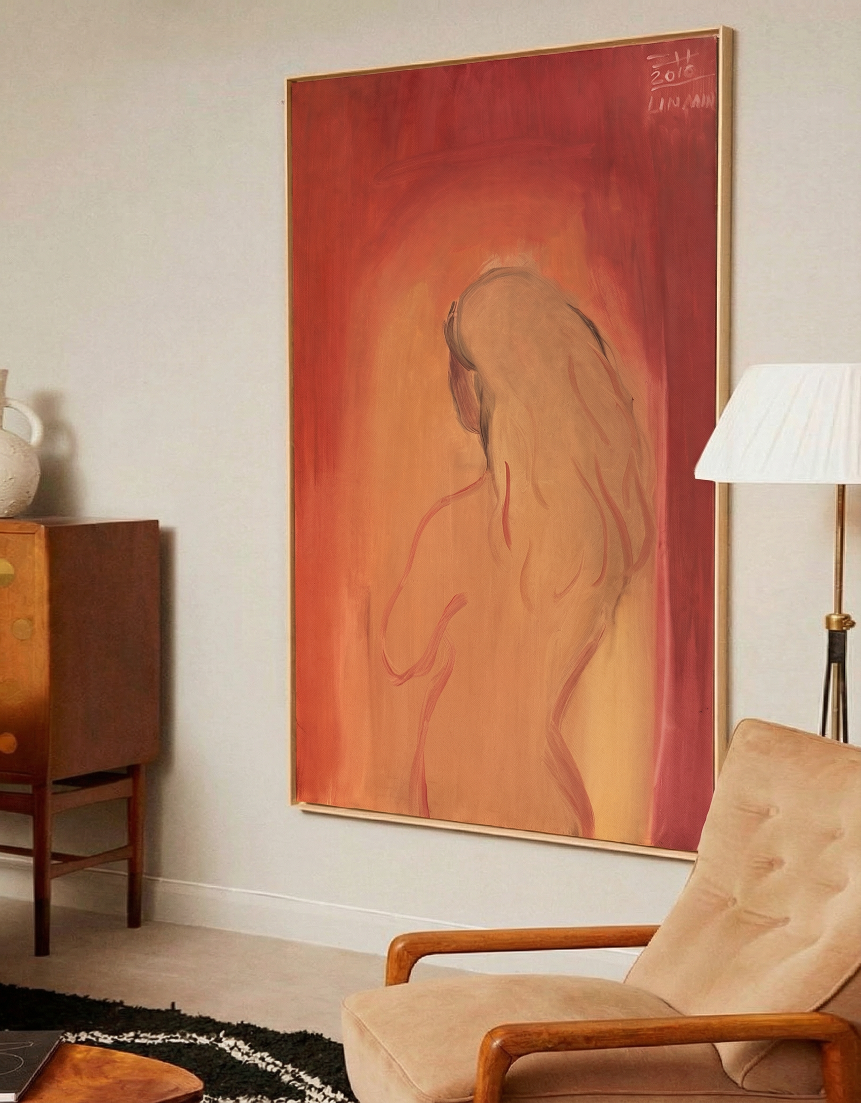 Abstract painting on a wall above a beige armchair in a room with a wooden cabinet and lamp. Presence – Contemporary Figurative Canvas Print | Luxury Wall Art | Brume Art