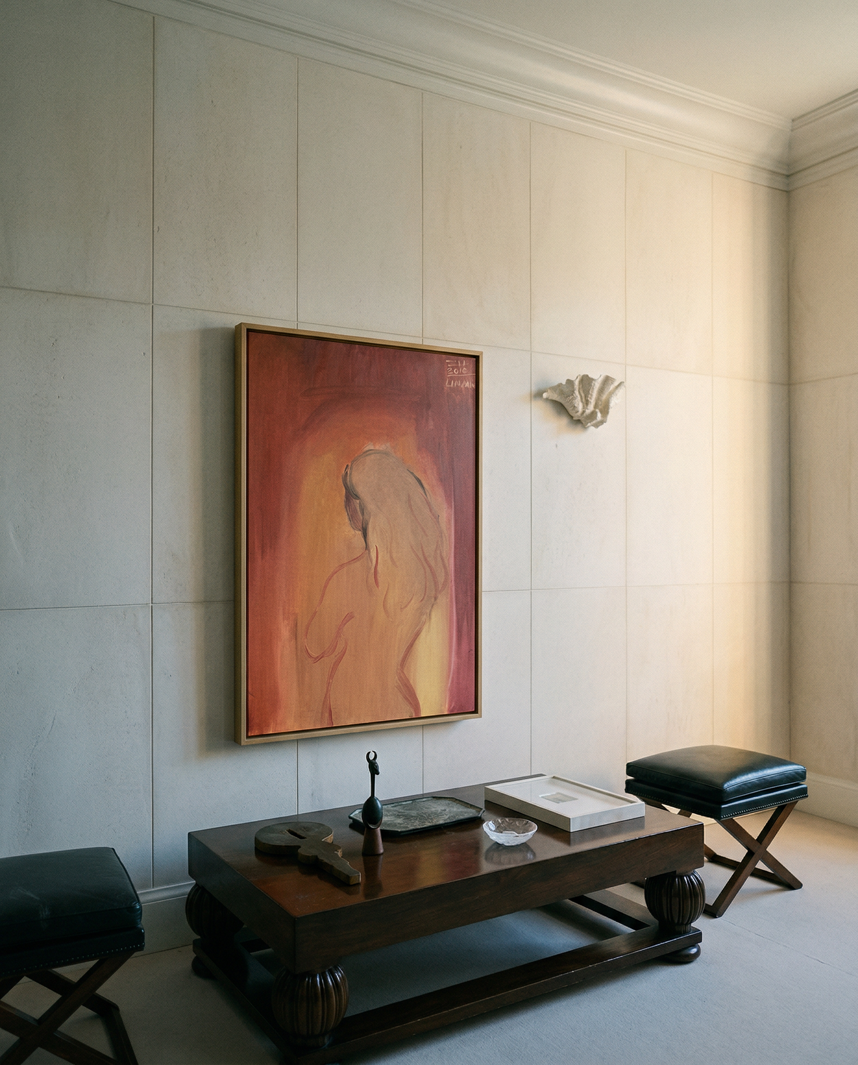 Room interior with a painting on the wall, a wooden table, and black stools. Presence – Contemporary Figurative Canvas Print | Luxury Wall Art | Brume Art